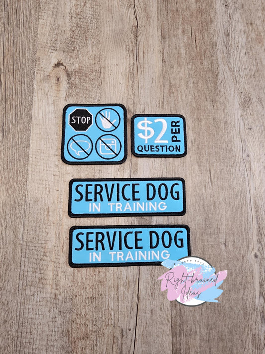 Service Dog, In Training&nbsp; Four-Piece Patch Set made with black and white embroidery thread on sky blue canvas material. All patches come with velcro sewn on the backside.
Set Includes:
(2) 6in x 2in rectangular patches: "Service Dog In Training"
(1) 3.5in square patch: four symbol patches asking to "Stop"Symbol, "Do Not Pet/Touch" Symbol, "No Questions" Symbol, and "No Photos" Symbol
(1) 3in x 2.5in rectangular patch: "$2 Per Question"